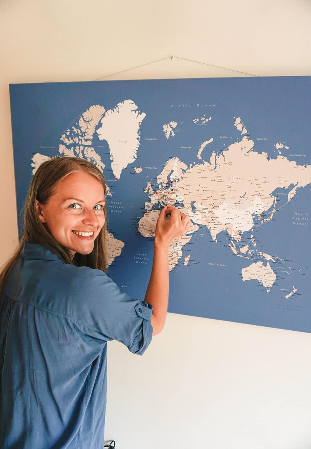 pinning world map hanged on a wire