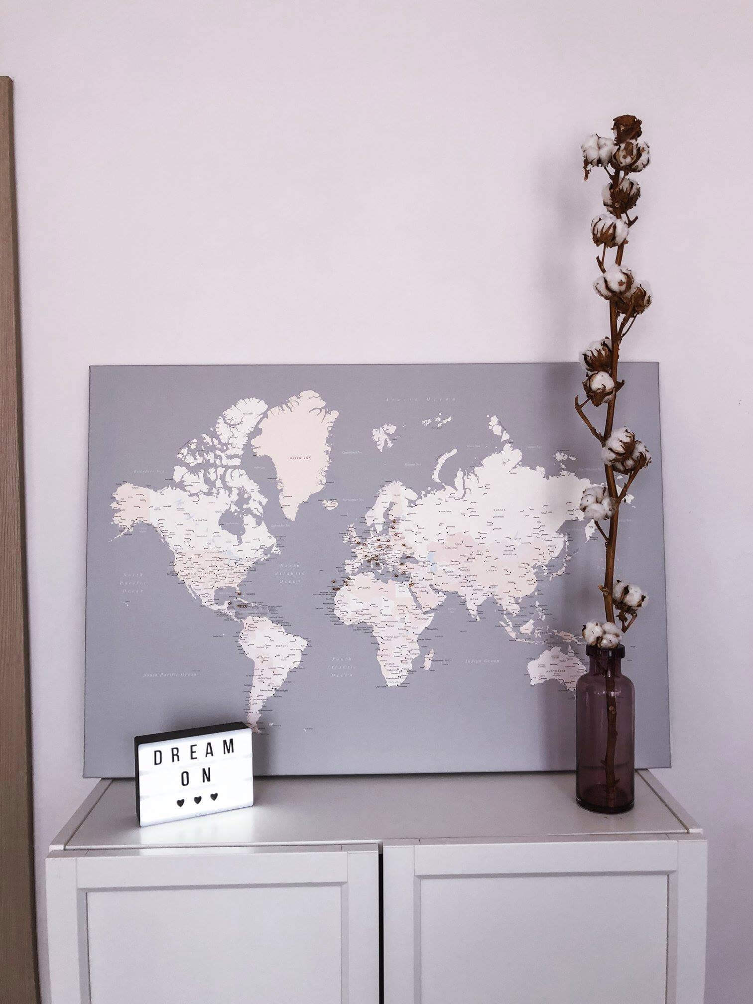 grey modern world map on canvas with push pins
