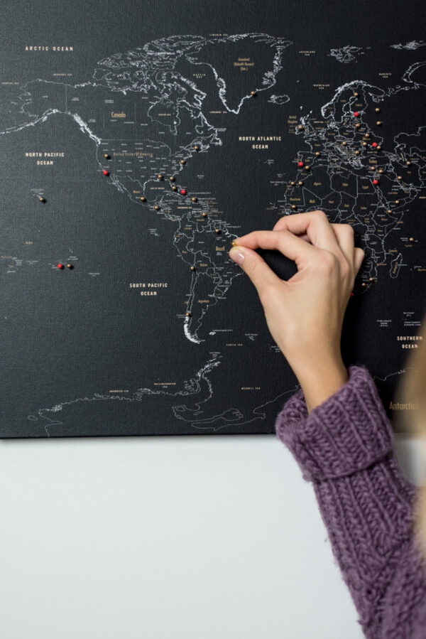 black push pin world map with golden pins